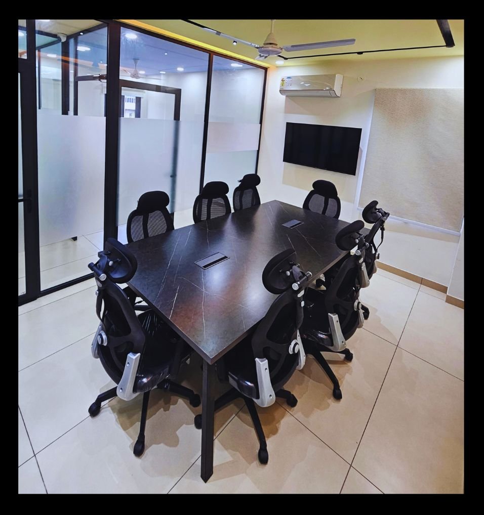 Boardroom with a large table and screen