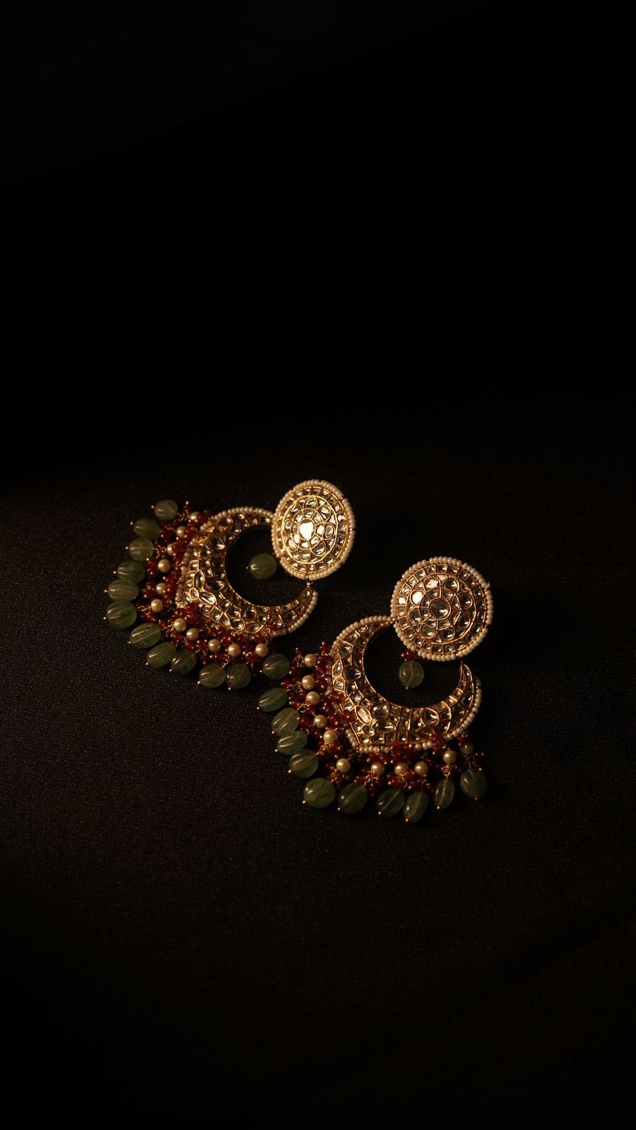 Gold jhumka earring product shot on black