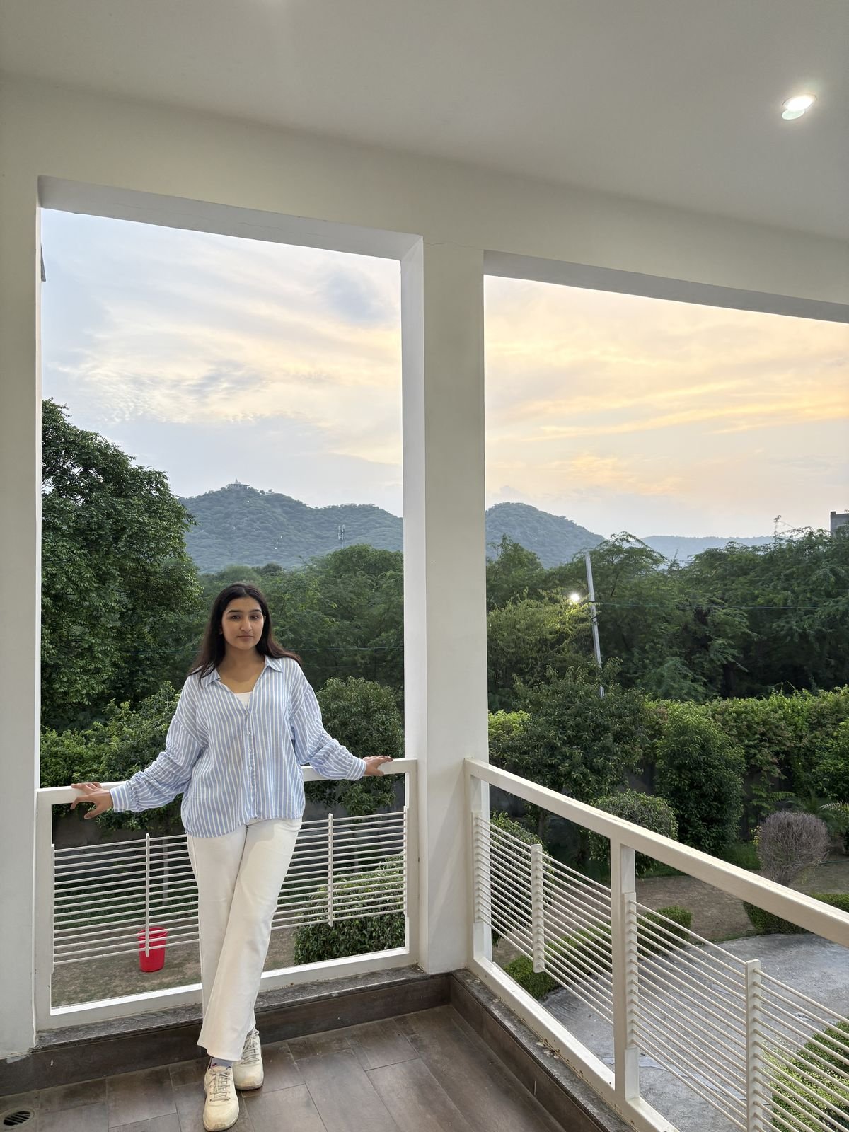 Guest on a villa balcony at sunset